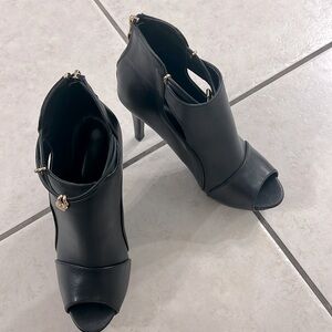 Black heels with zip on back heel, NEVER worn!!